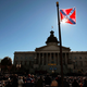 A Confederate flag that’s part of a Civil War memorial on the grounds of the South Carolina Statehouse flies over a Martin Luther King Day rally Jan. 21, 2008, in Columbia, S.C. (Chris Hondros/Getty Images)